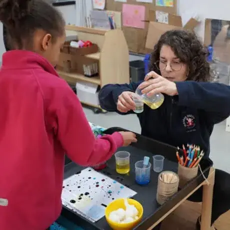 Staff and preschool children doing science experiment Staff and preschool children doing science experiment
