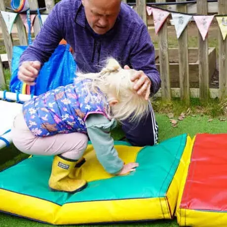 Nursery child learning to roll forward Nursery child learning to roll forward
